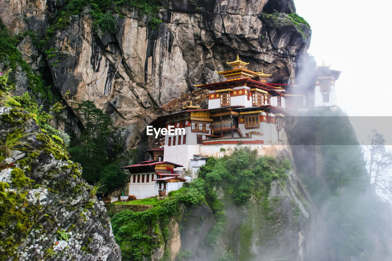 Temple by mountain against sky