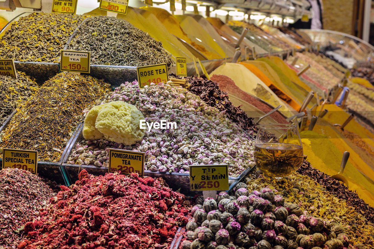 Close-up of various herbal teas with tags at market stall