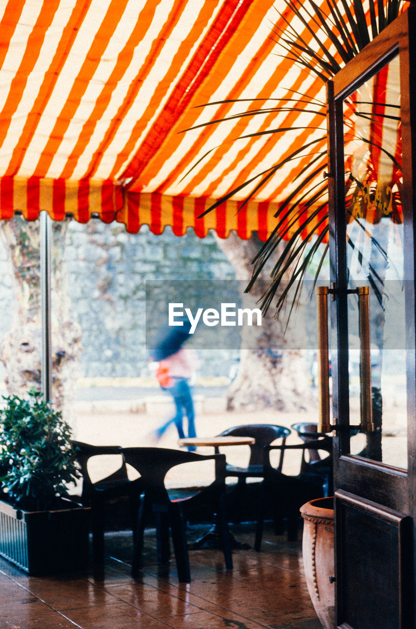 Chairs and table at porch of restaurant