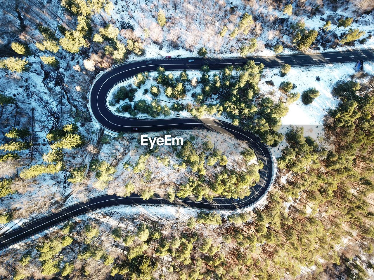 High angle view of road amidst trees in winter