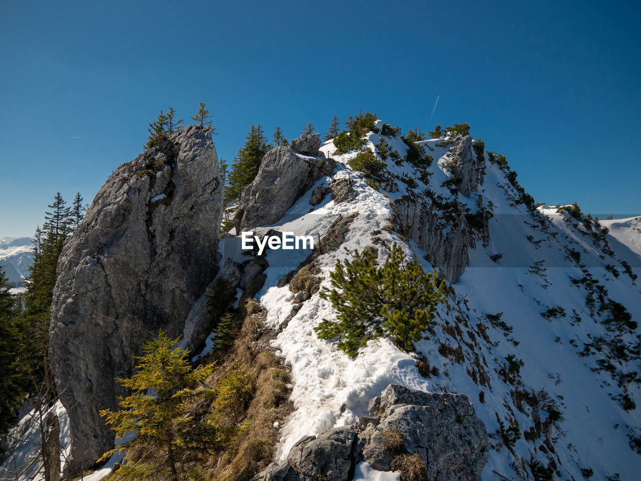 Low angle view of snowcapped mountains against clear sky