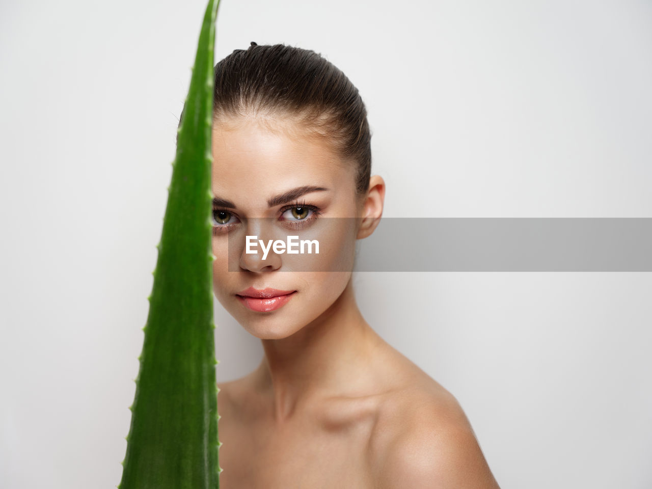 Portrait of young woman against white background