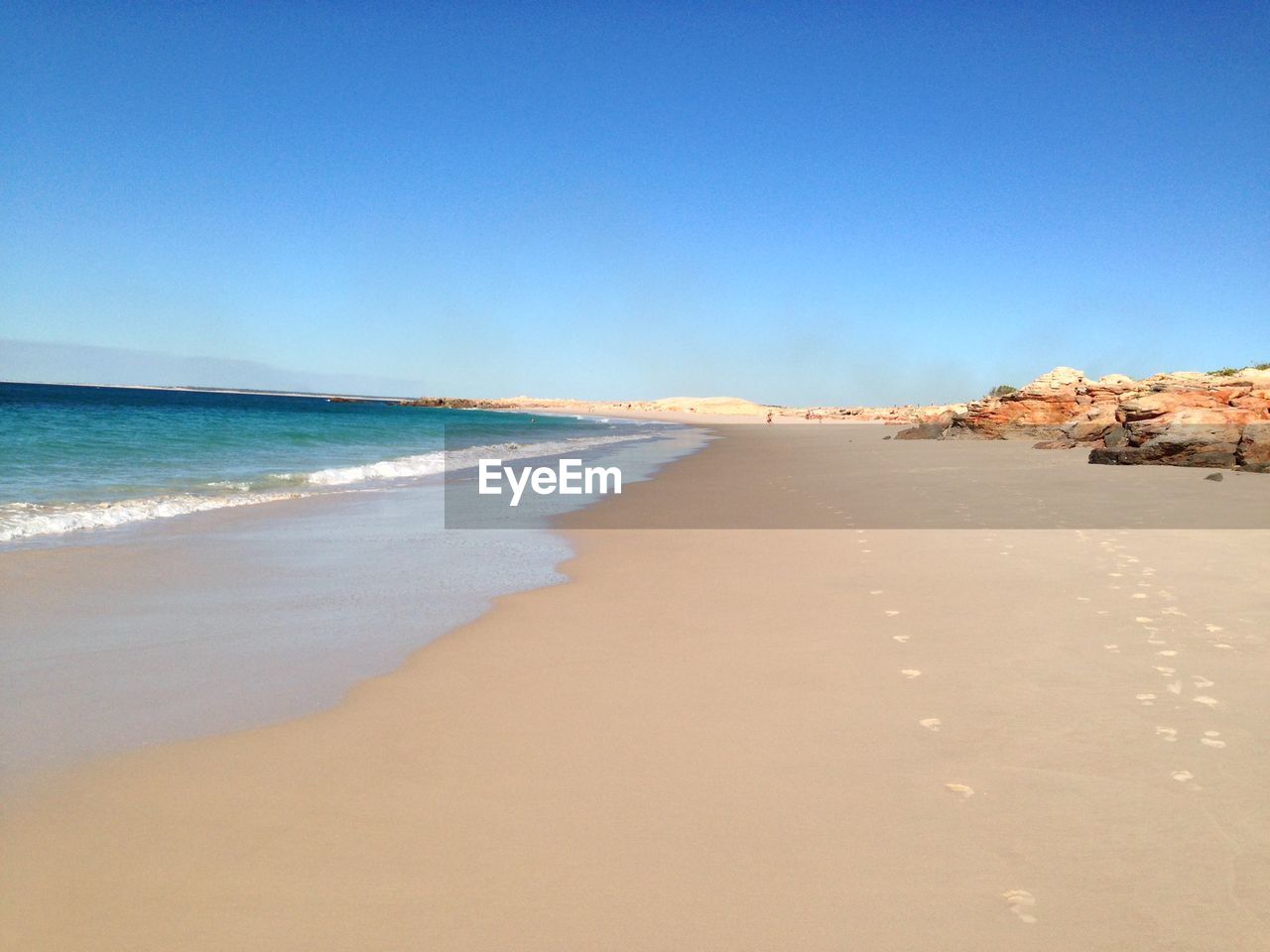 VIEW OF BEACH AGAINST BLUE SKY