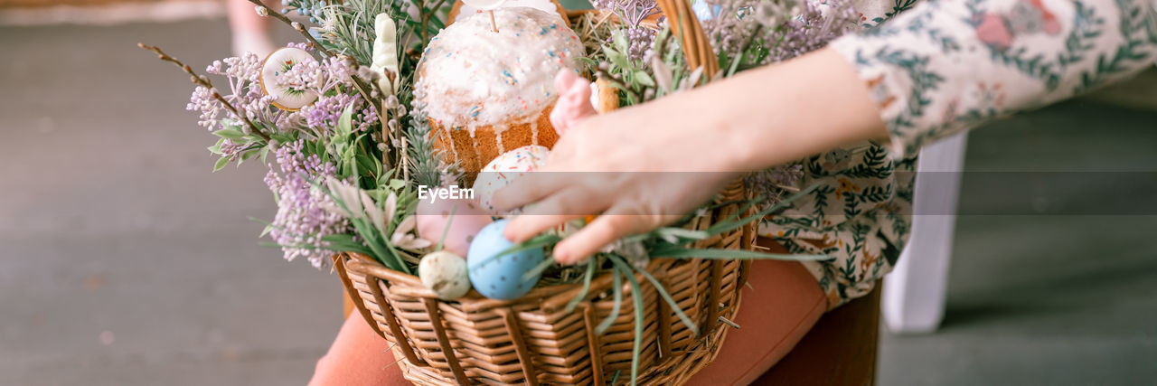 spring, one person, adult, hand, women, flower, holding, plant, nature, basket, freshness, flowering plant, midsection, floristry, day, bouquet, outdoors, yellow, close-up, lifestyles, female, floral design, focus on foreground, food, food and drink, flower arrangement