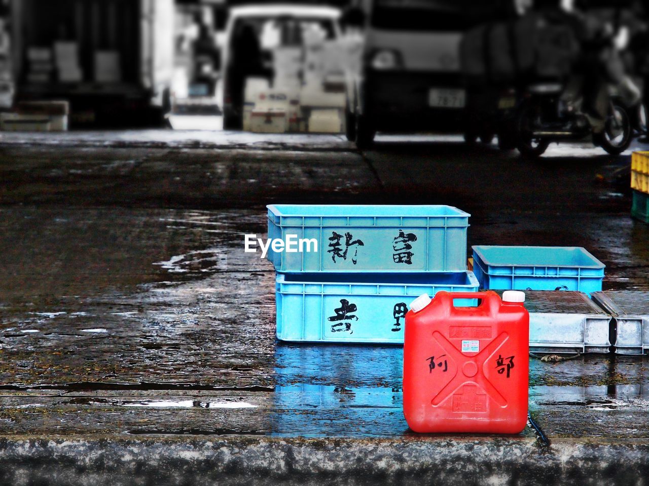 Crates on wet footpath