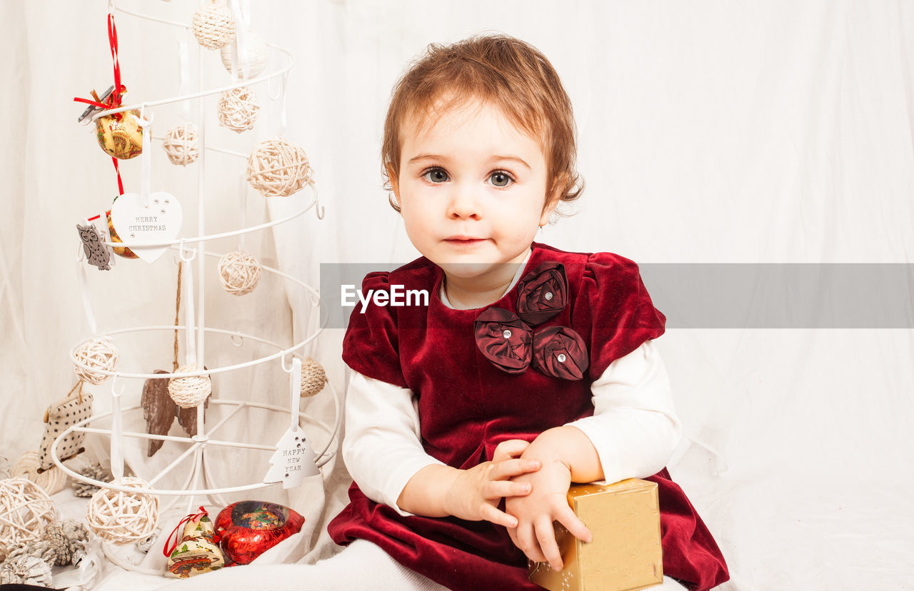 Portrait of girl with christmas present at home