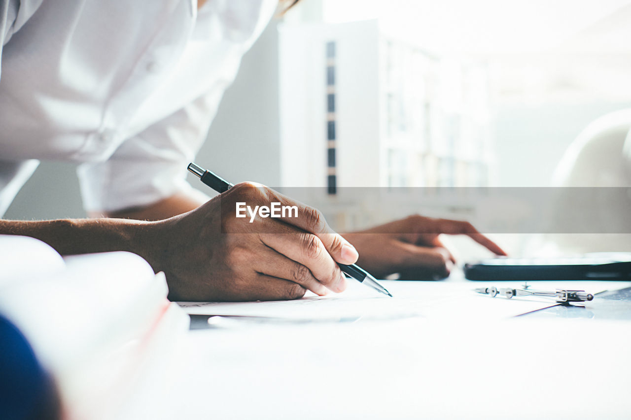 Midsection of woman working in office