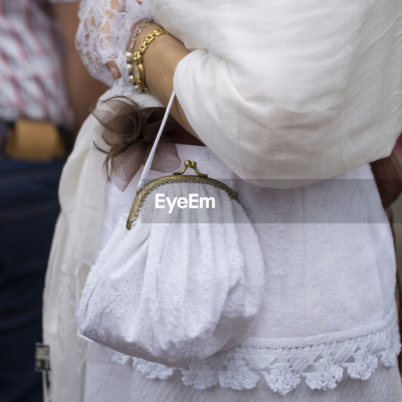 Midsection of woman holding purse