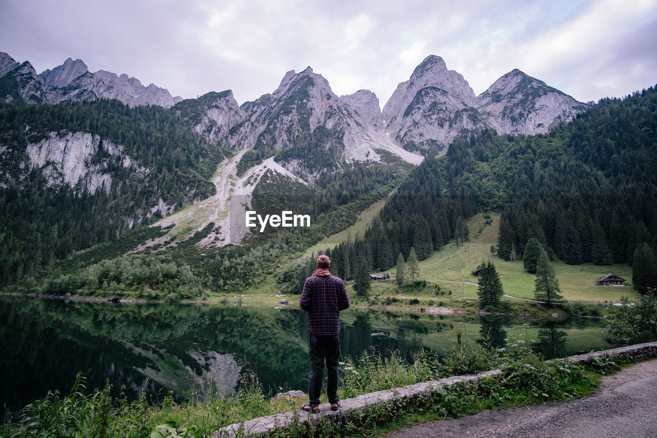 Man looking at mountains against sky