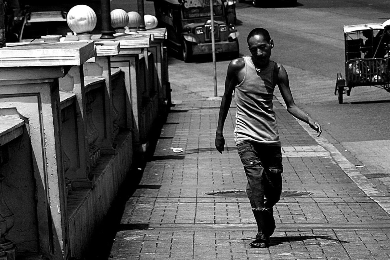 Full length of a man walking on road