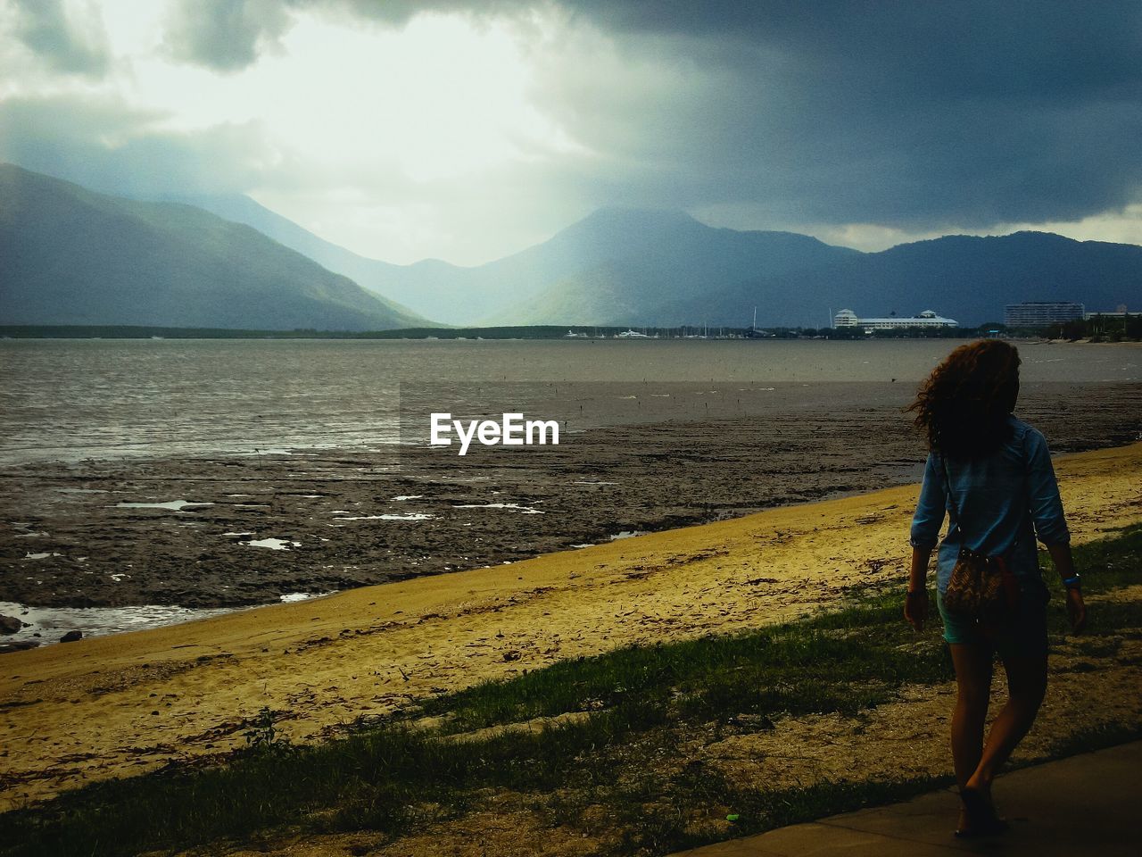 SCENIC VIEW OF SEA WITH MOUNTAIN IN BACKGROUND