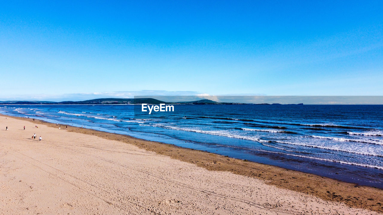 SCENIC VIEW OF BEACH AGAINST CLEAR SKY