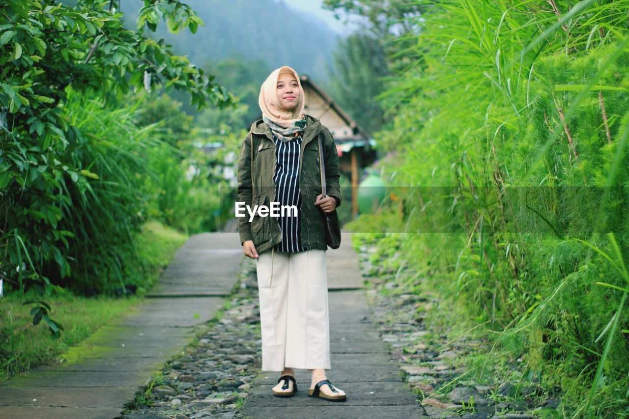 A pregnant woman smile in the park. taken at salatiga january 2020