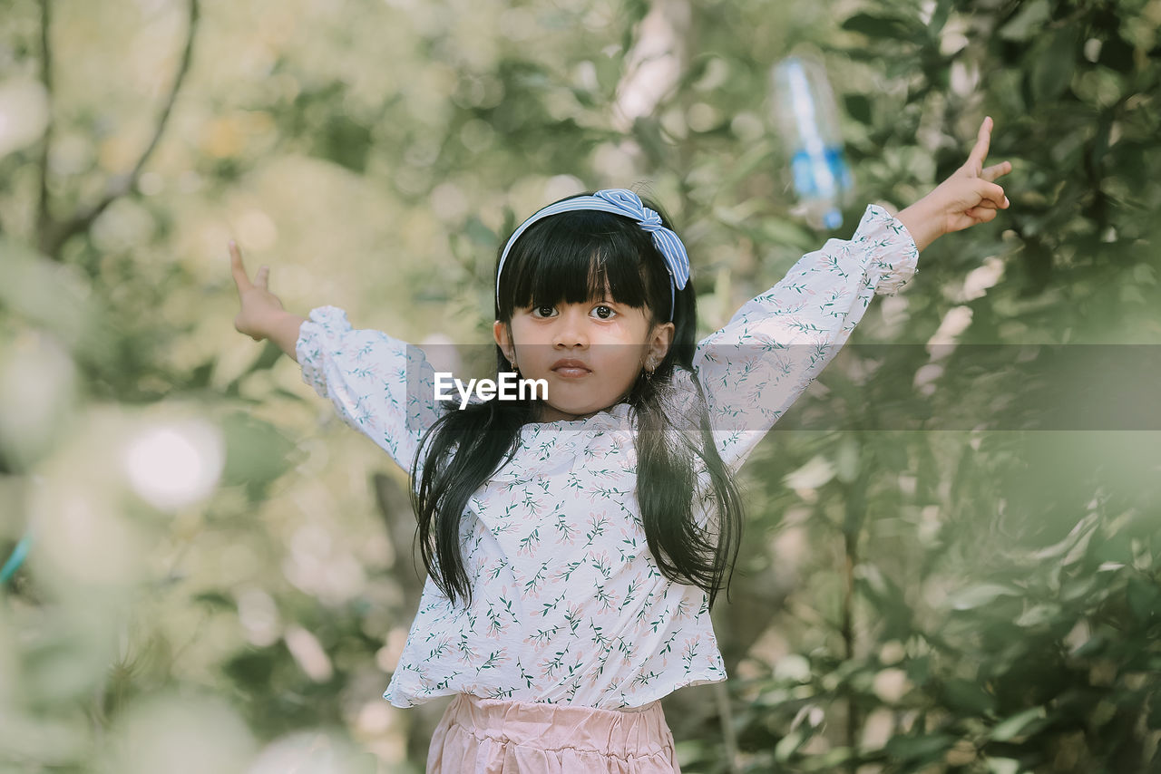 Portrait of cute girl standing outdoors