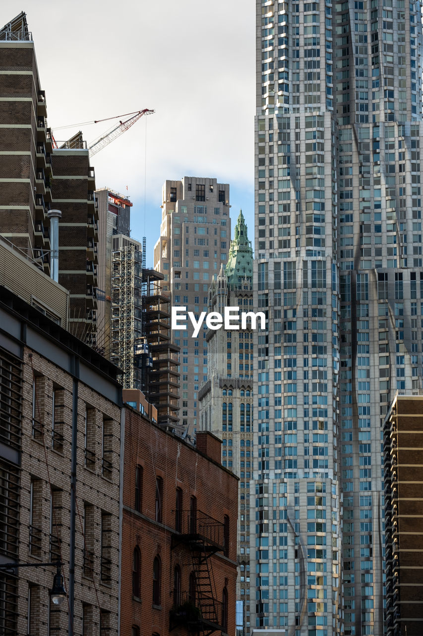 LOW ANGLE VIEW OF MODERN BUILDINGS AGAINST SKY