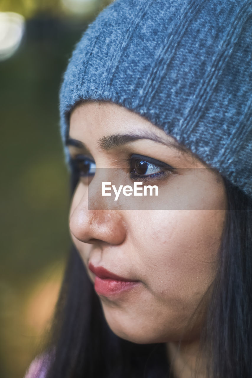 Close-up of thoughtful young woman at park