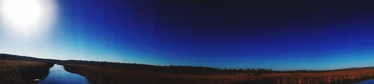 PANORAMIC SHOT OF LAND AGAINST CLEAR BLUE SKY