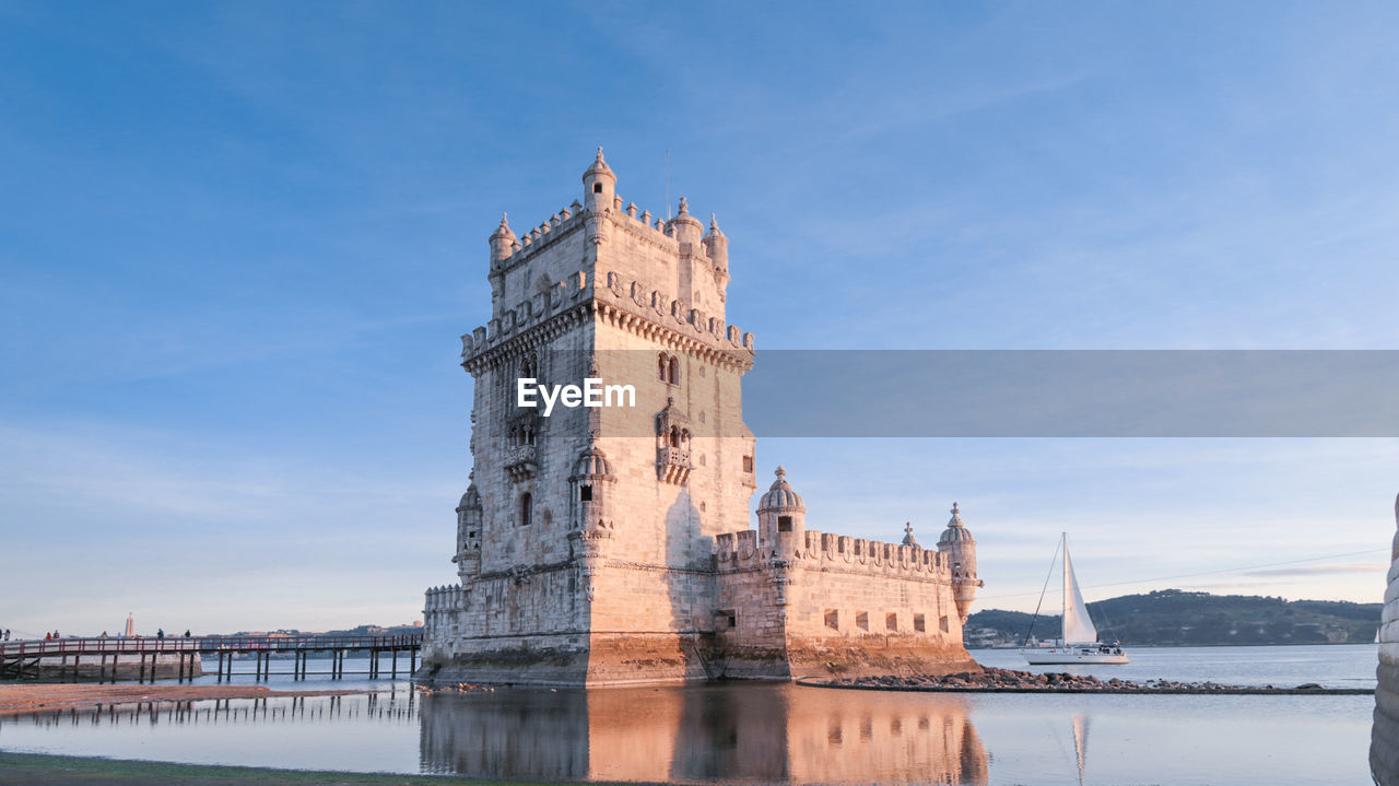 VIEW OF BUILDING AGAINST SKY WITH WATERFRONT