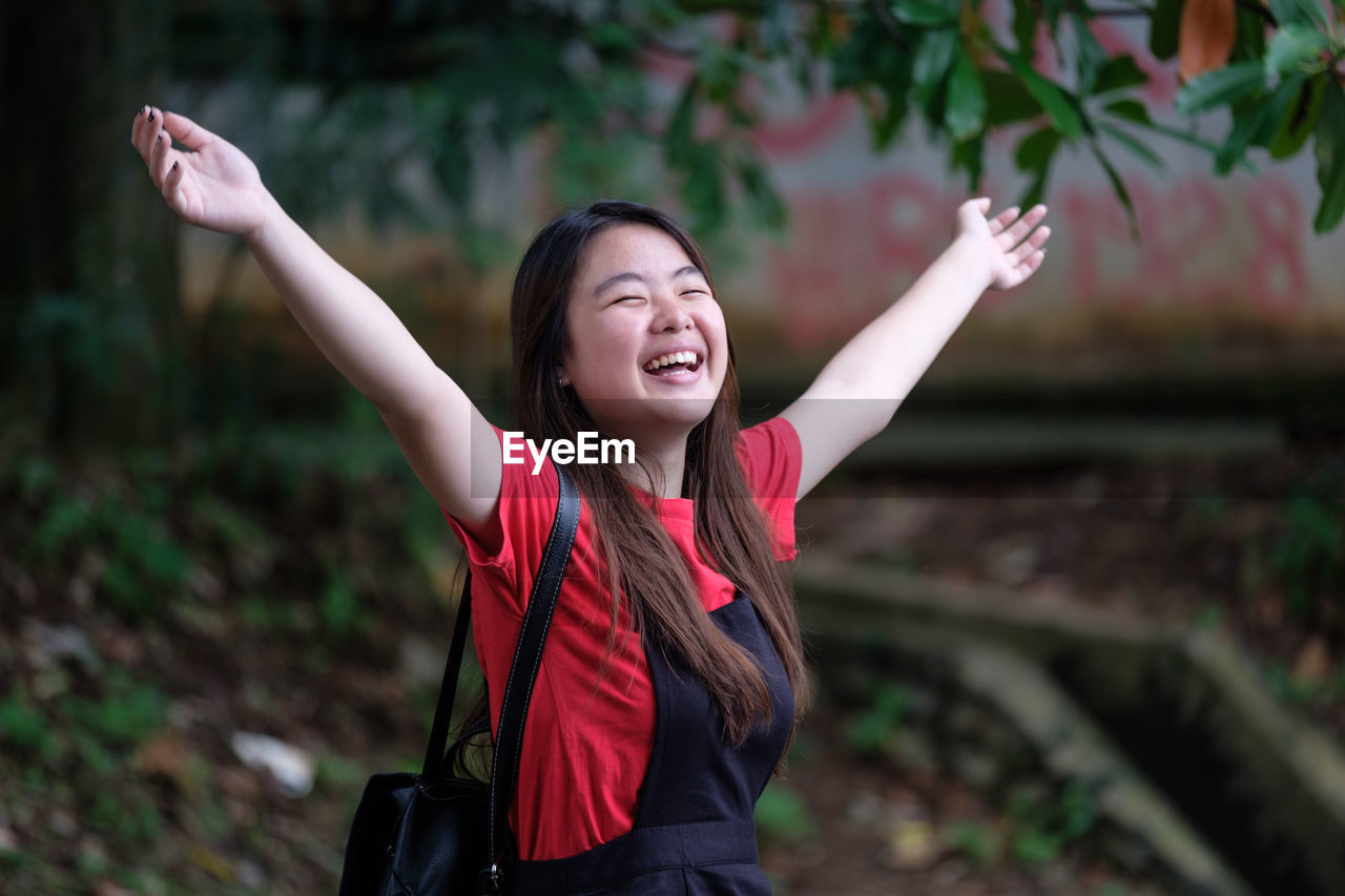 Smiling young woman at park