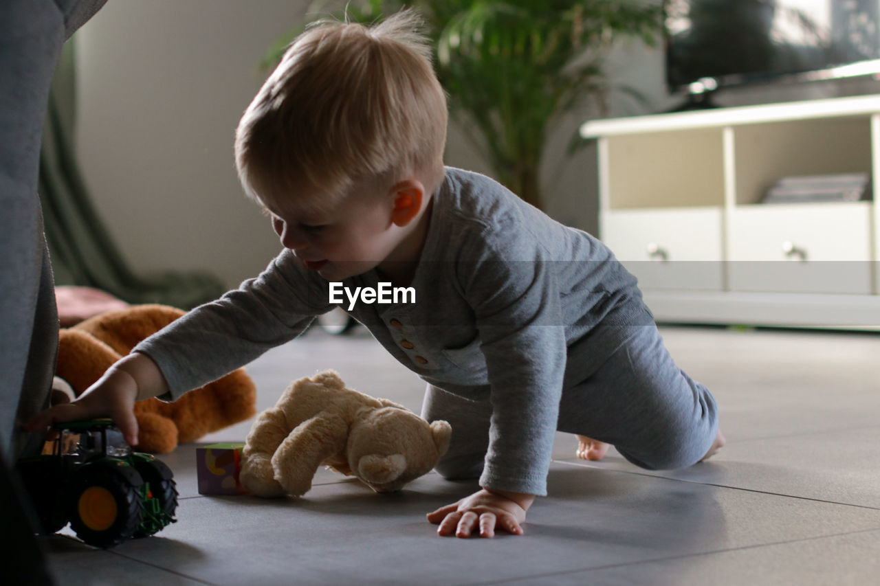 close-up of boy playing with toy at home