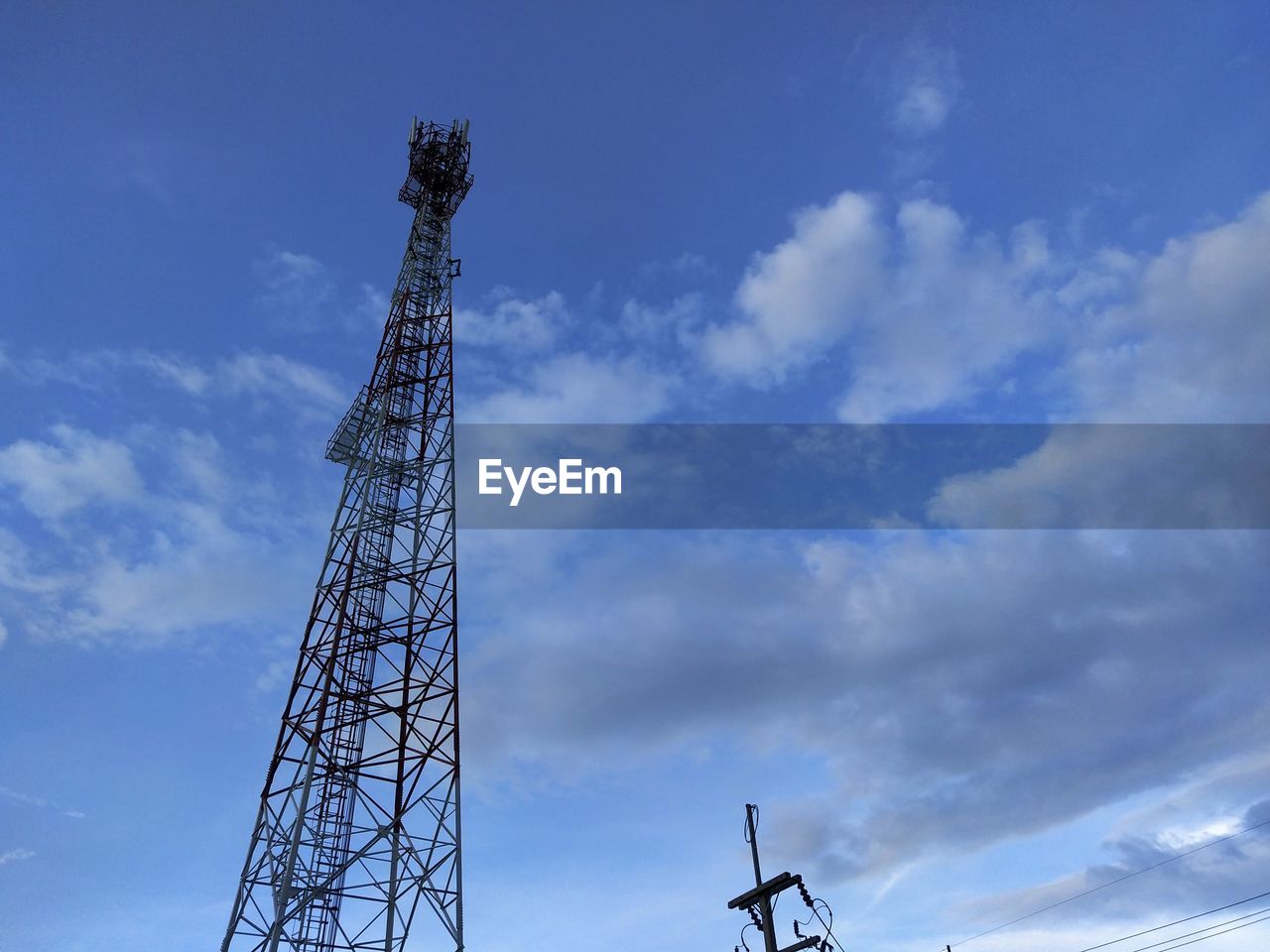 Low angle view of crane against sky