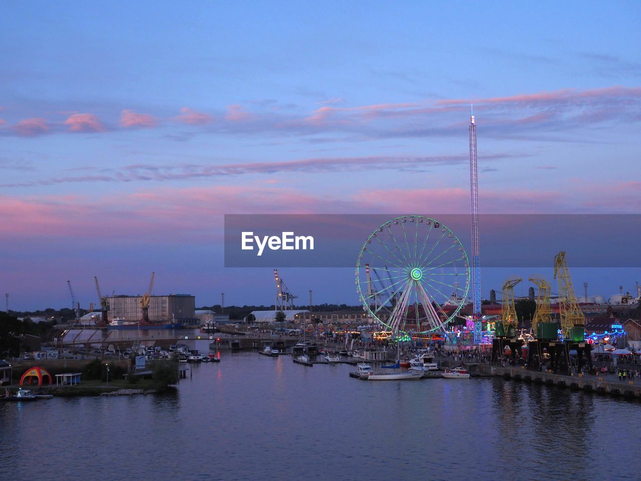 ferris wheel, amusement park ride, amusement park, water, architecture, sky, arts culture and entertainment, city, built structure, travel destinations, dusk, nature, harbor, transportation, sea, sunset, building exterior, reflection, cityscape, evening, nautical vessel, travel, cloud, outdoors, no people, horizon, tourism, night, multi colored, building, skyline, illuminated, landscape, mode of transportation, marina, carnival, dock, port