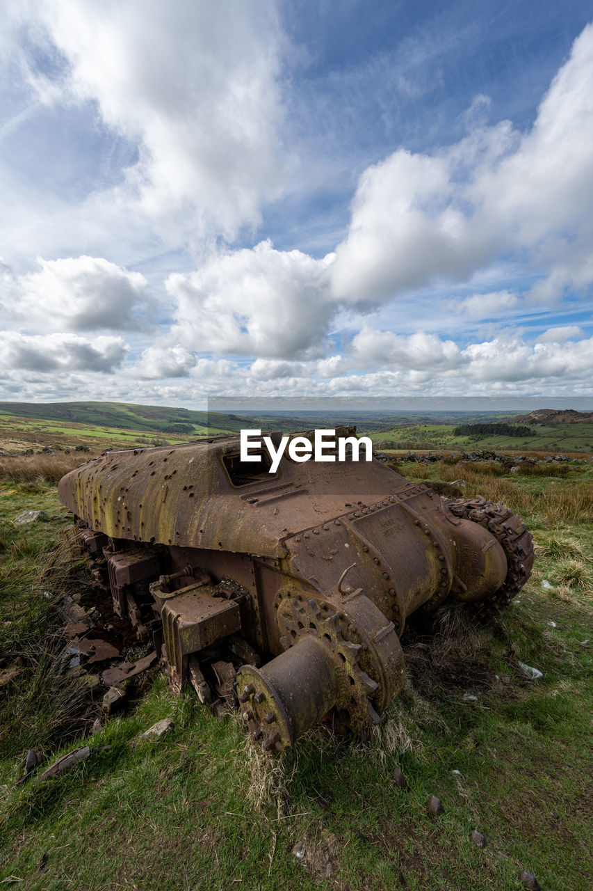 cloud, sky, environment, nature, landscape, land, no people, grass, rural area, day, scenics - nature, outdoors, plant, history, natural environment, terrain, rock, field, abandoned, the past, travel destinations, non-urban scene, travel, transportation, vehicle, hill