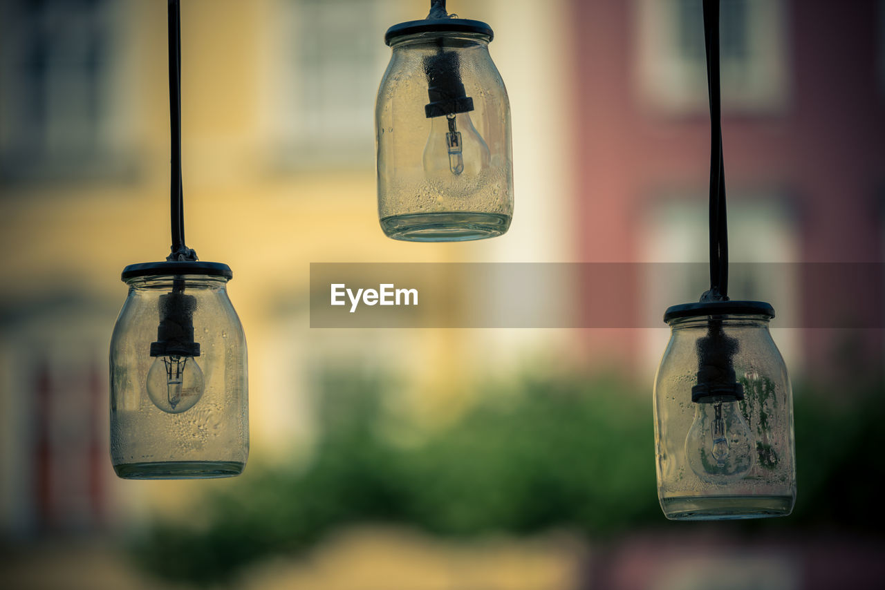 CLOSE-UP OF LIGHT BULB HANGING IN GLASS