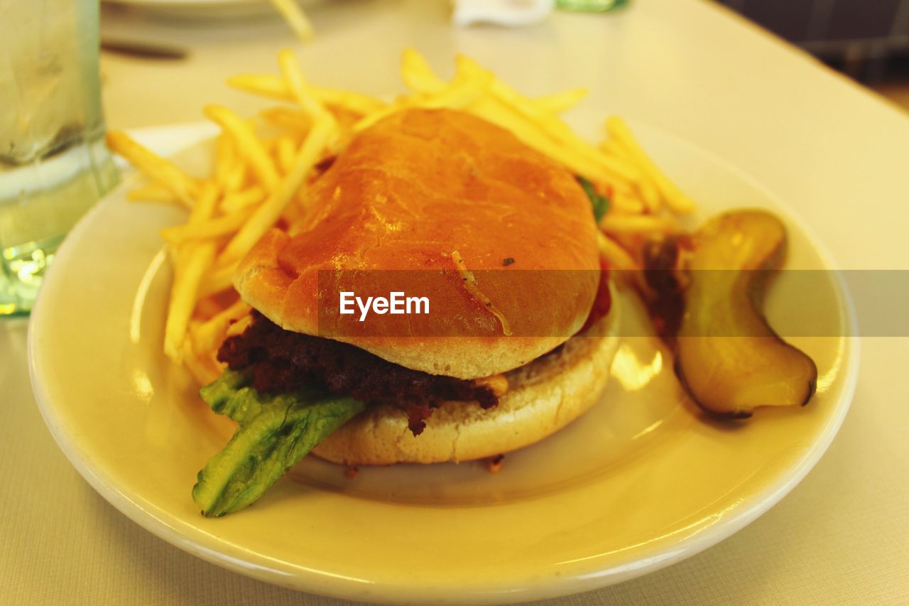 Close-up of burger with french fries on table at restaurant