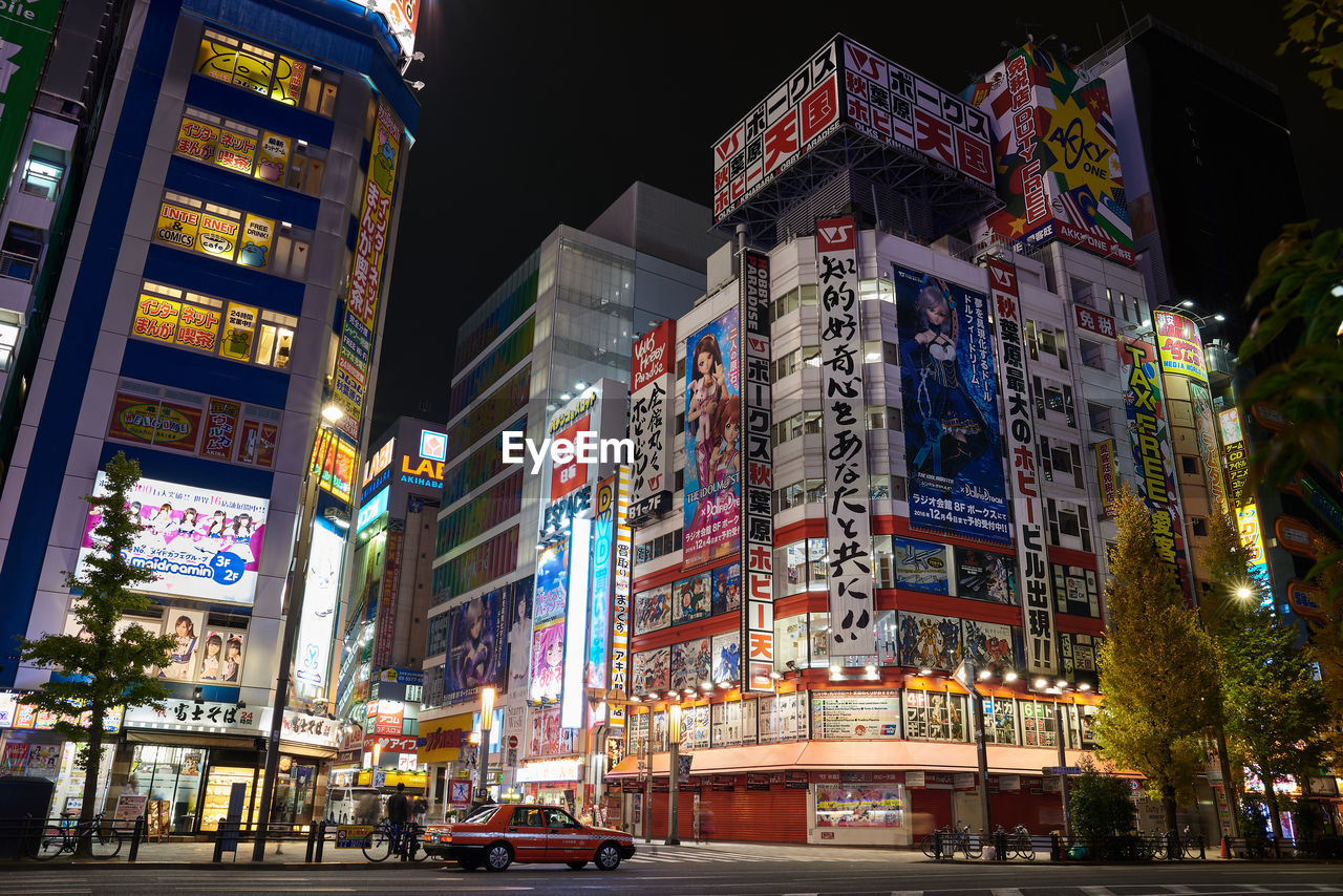 Illuminated city against sky at night