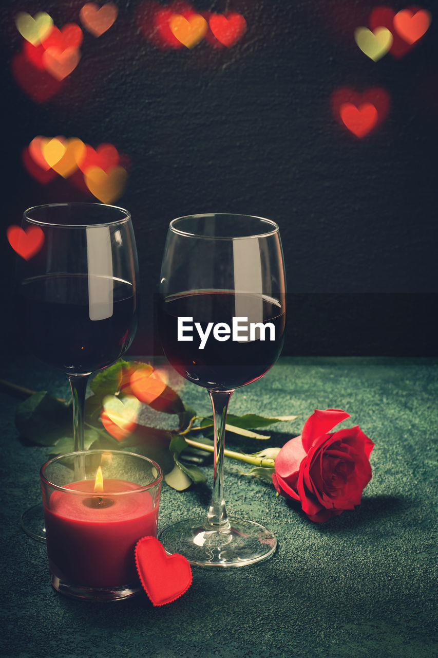 Valentines day greeting card concept. wine glasses, rose and candle