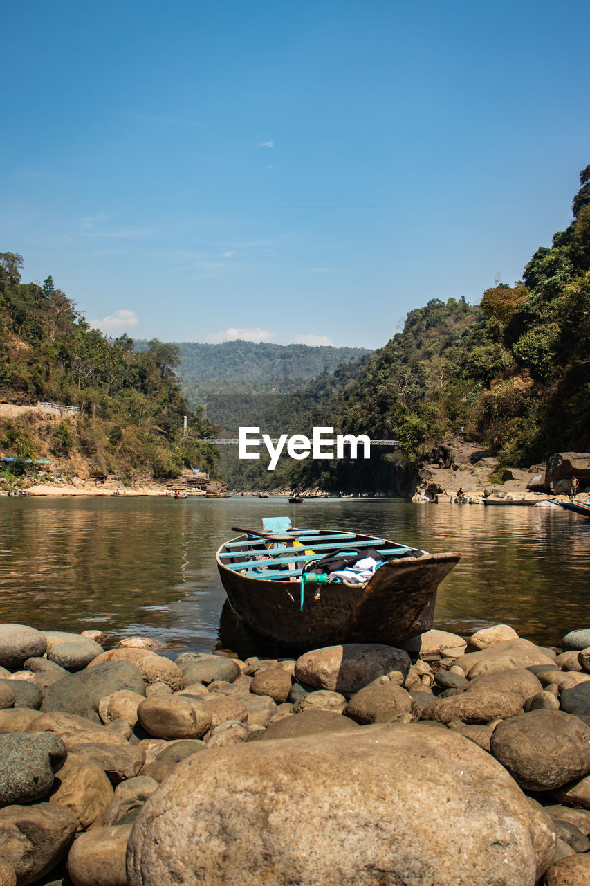 Fishing boat at river shore at morning from flat angle