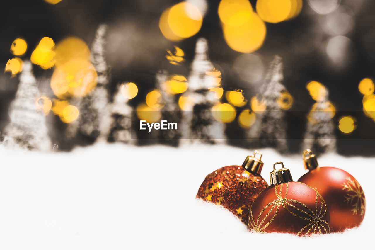 Close-up of christmas decorations on snow