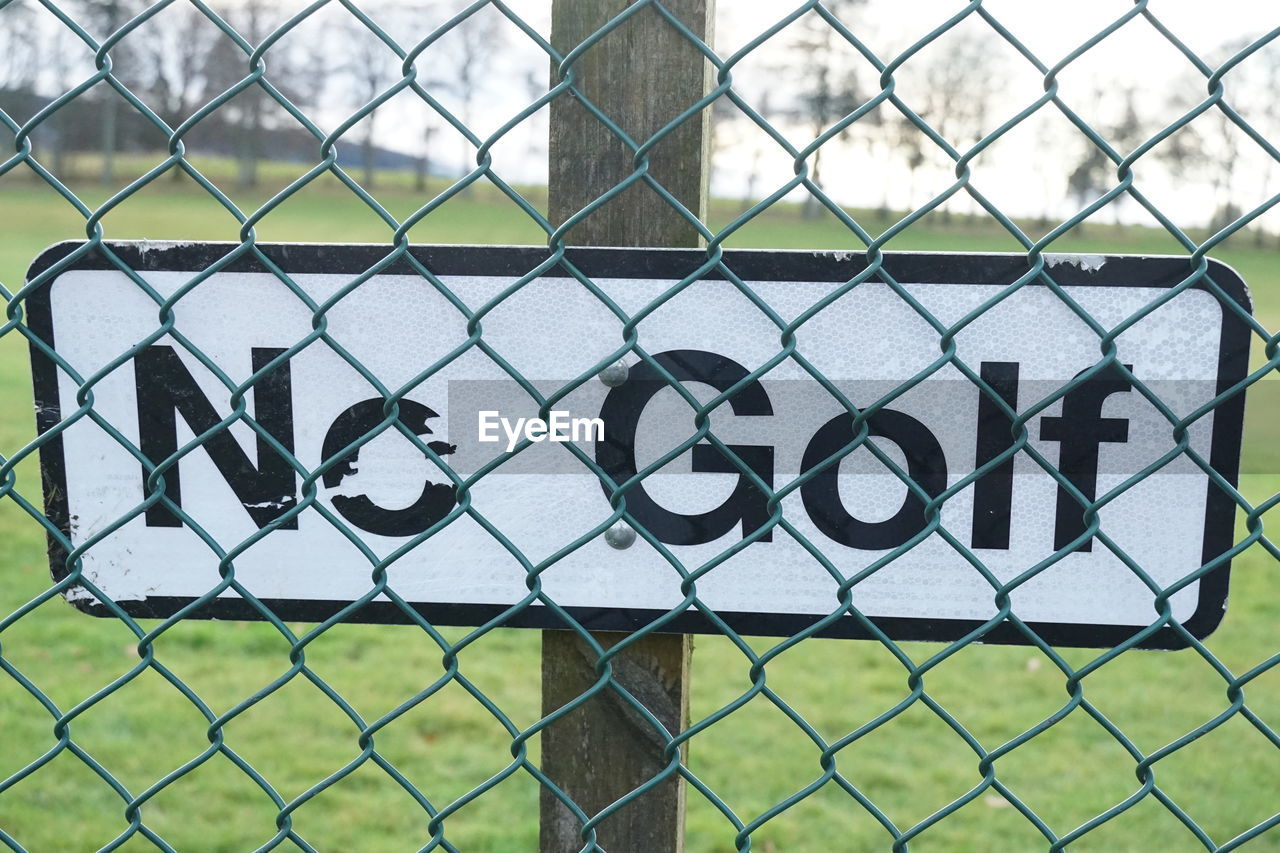 FULL FRAME SHOT OF CHAINLINK FENCE SEEN THROUGH WIRE