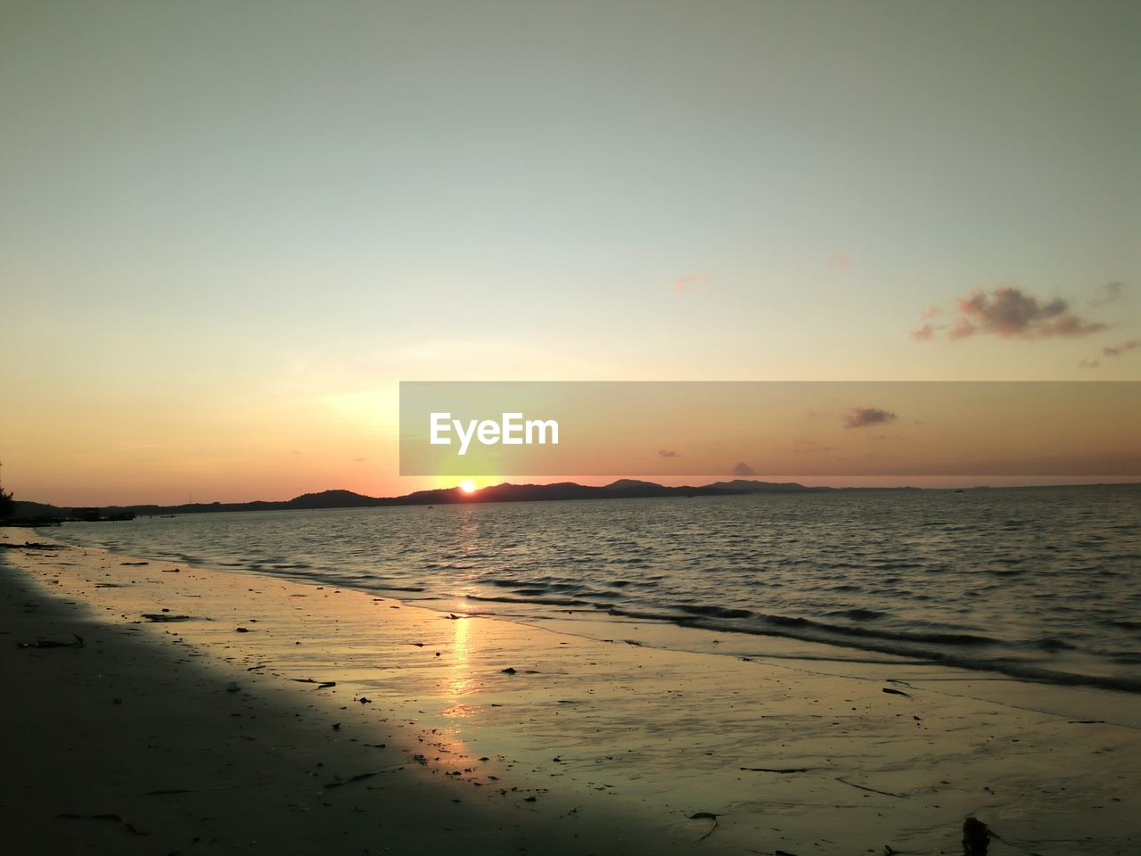 SCENIC VIEW OF BEACH DURING SUNSET