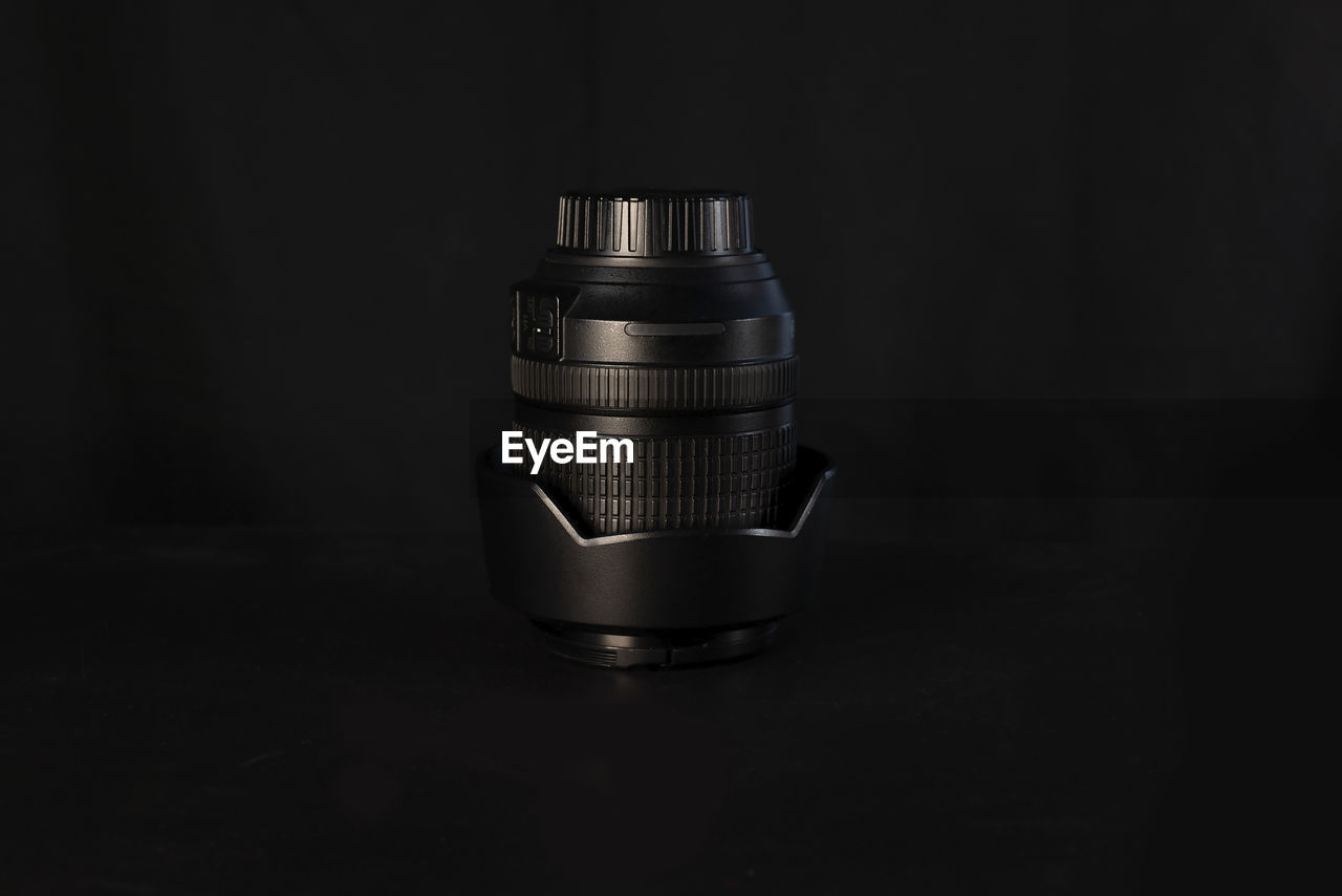 Modern camera lens on black background. close-up. space for text. and photography concept