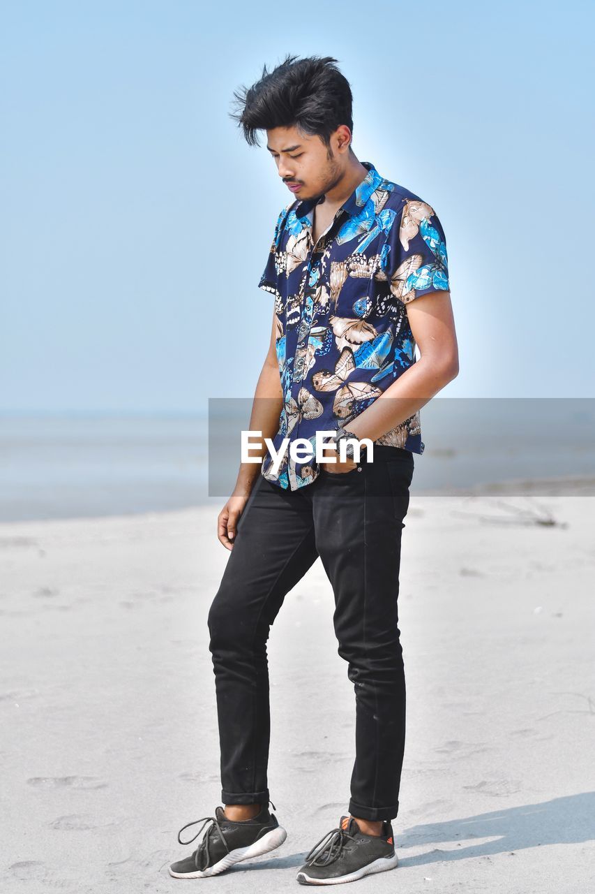 Full length of man standing on beach