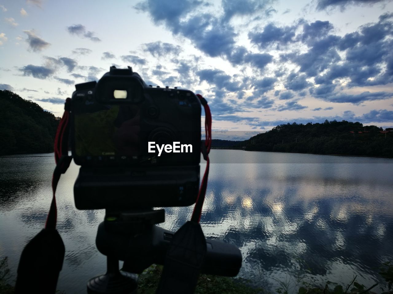 CLOSE-UP OF CAMERA AGAINST SEA