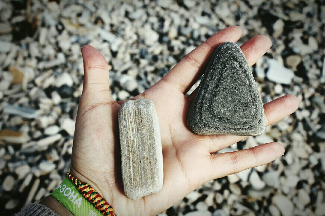 Close-up of a hand holding stones