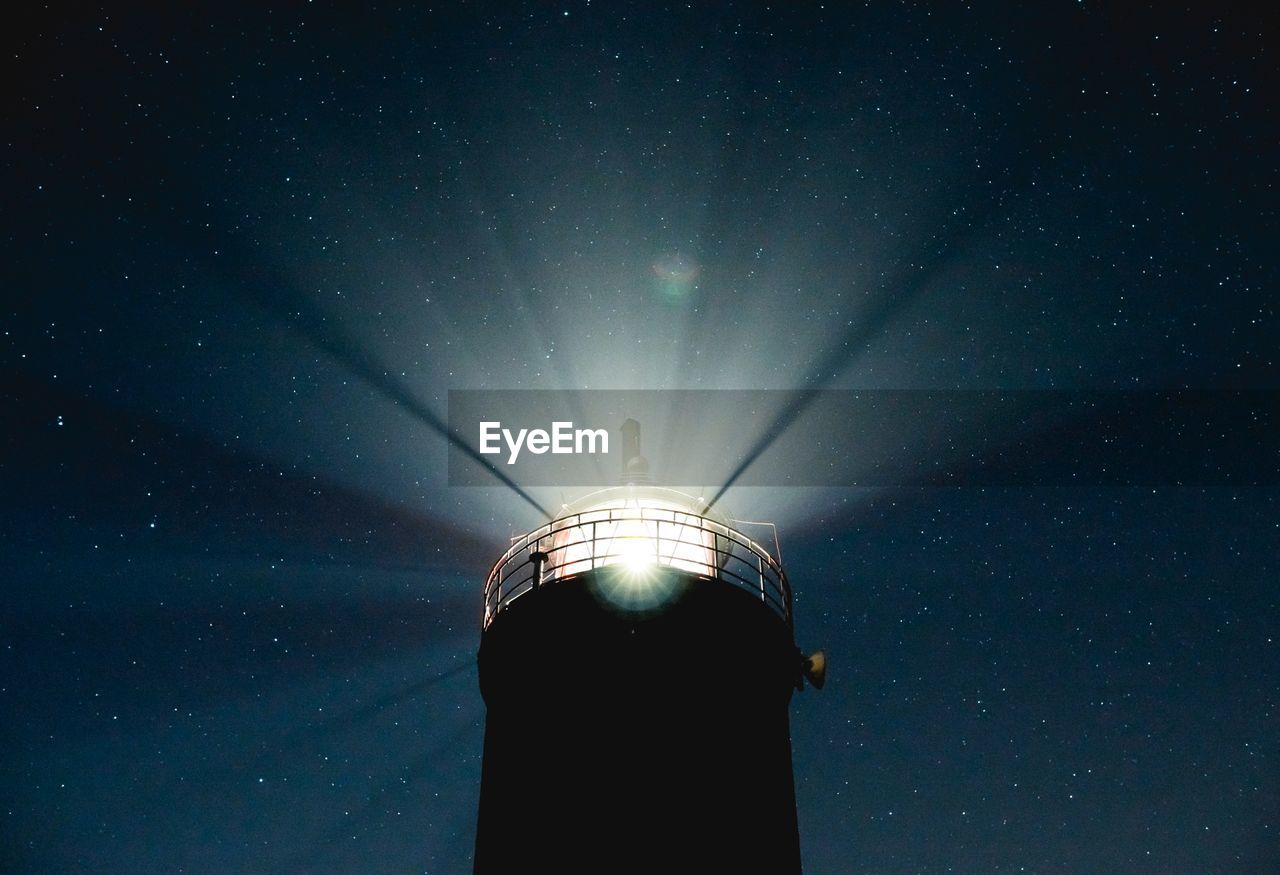 Close-up of lighthouse against clear sky at night