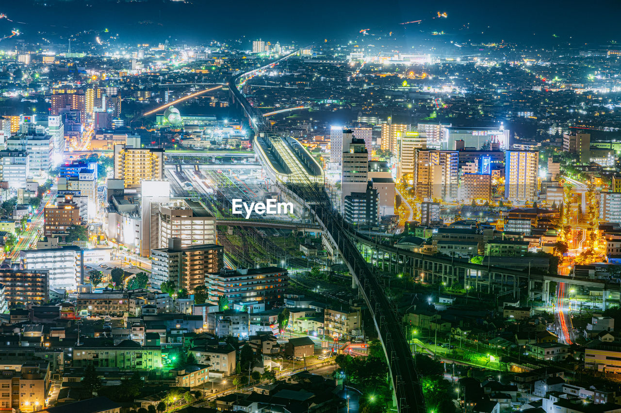 High angle view of illuminated buildings in city at night