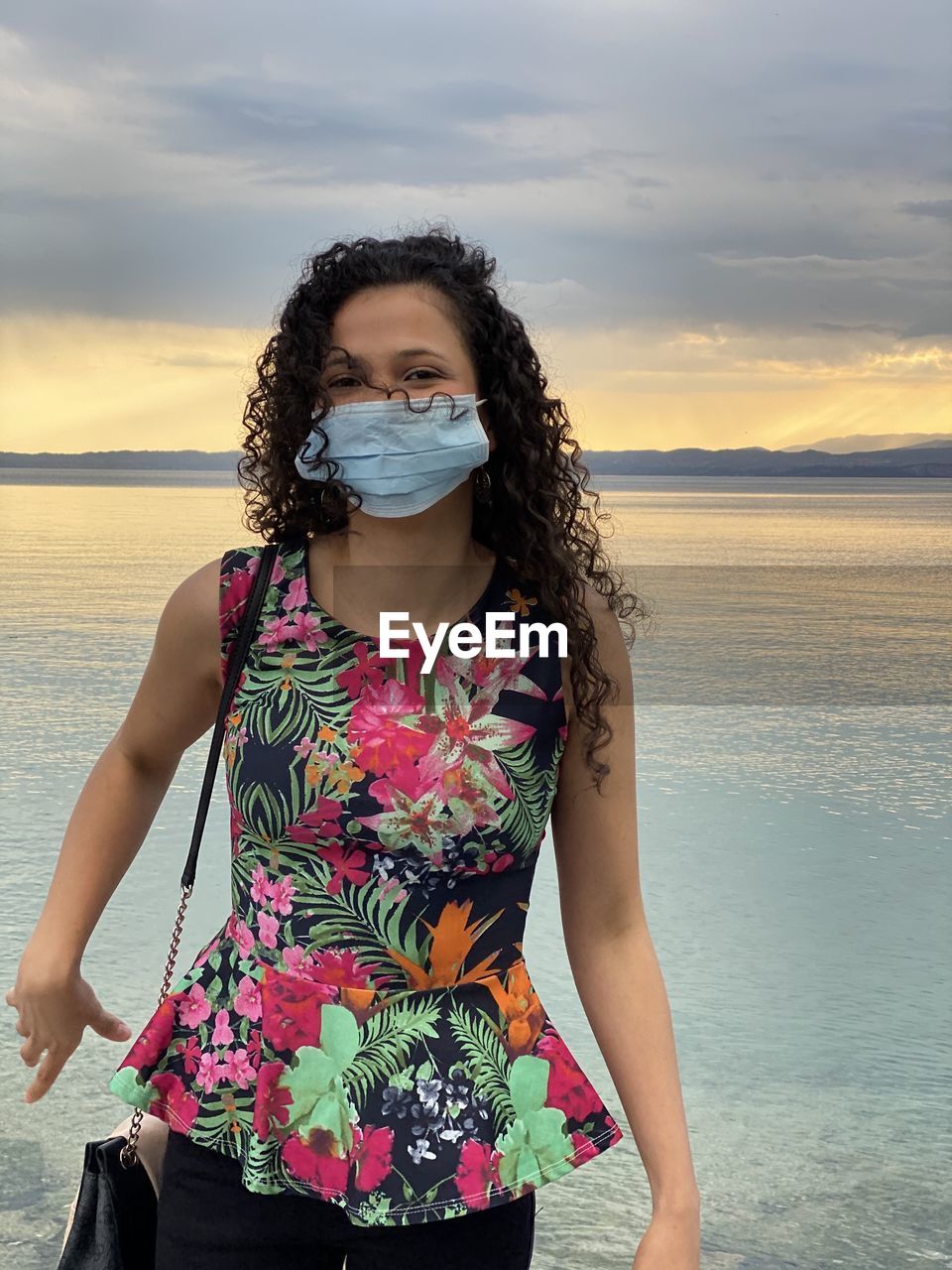 BEAUTIFUL WOMAN STANDING IN SEA AGAINST SKY