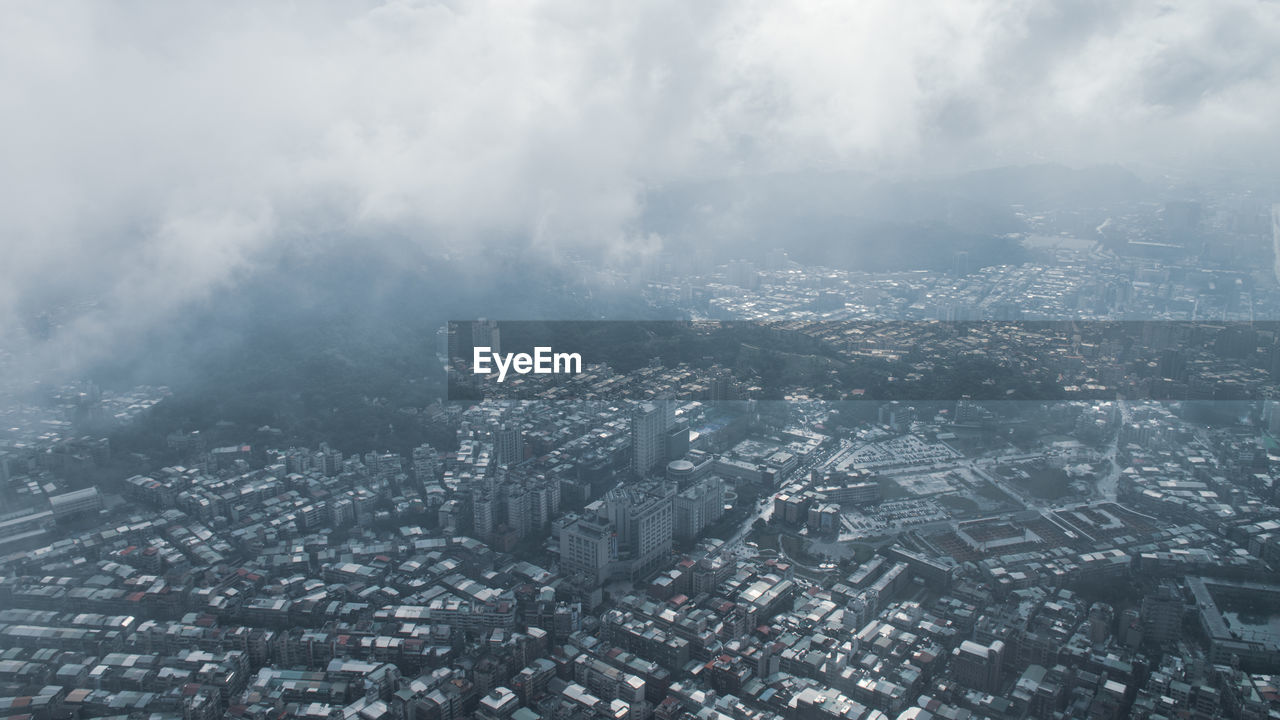 High angle view of buildings in city against sky