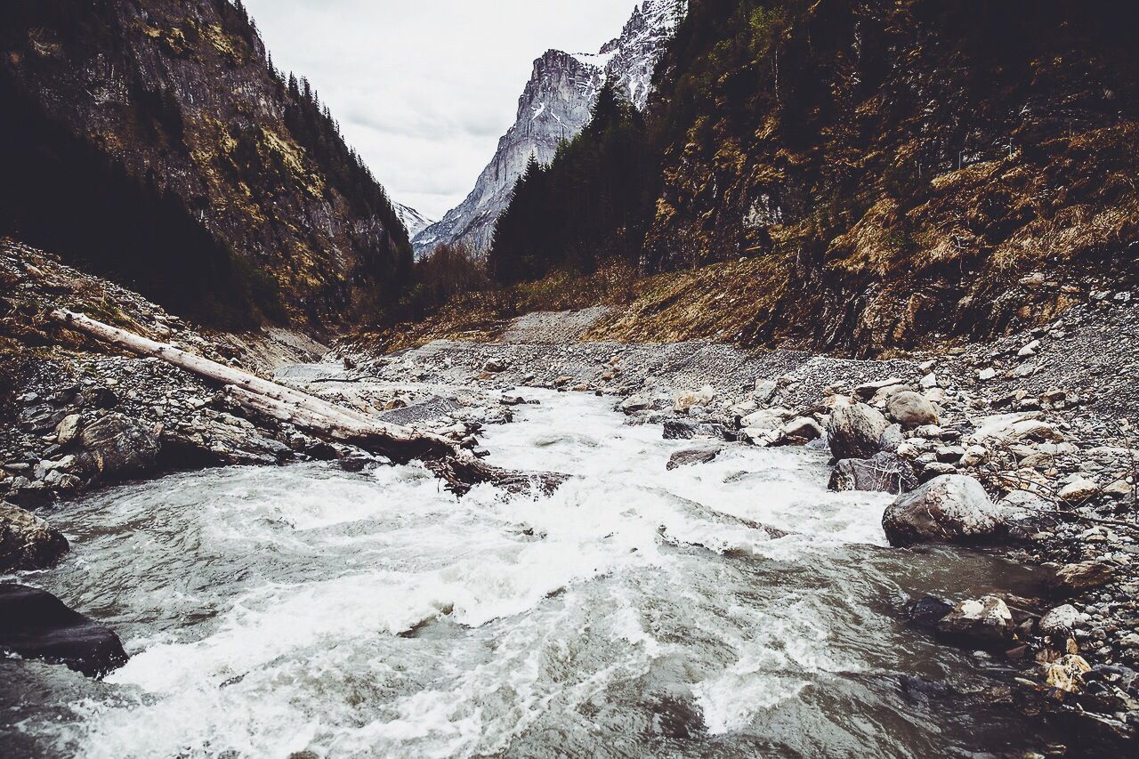 River flowing against rocky mountains