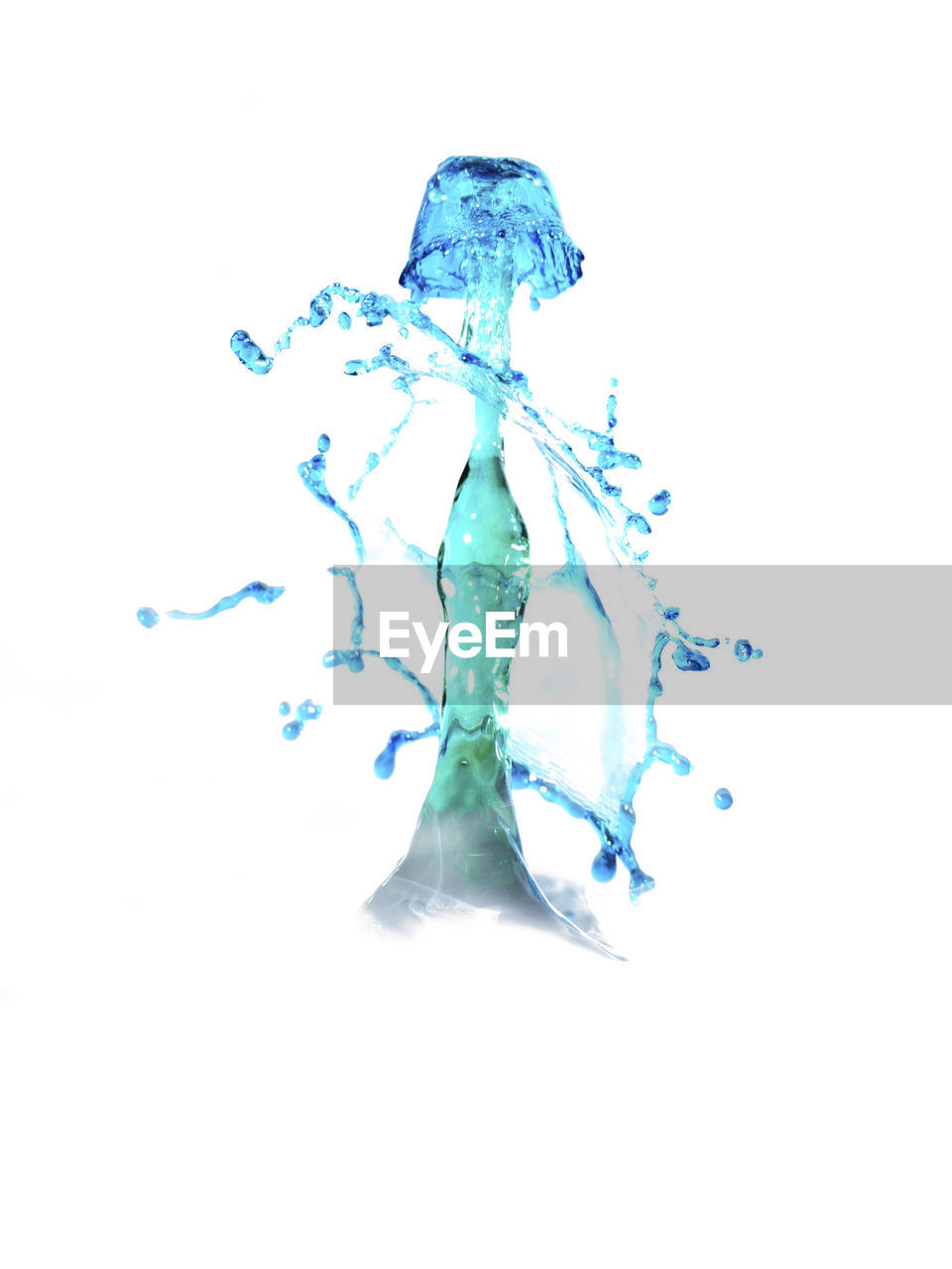 Close-up of blue water splashed against white background