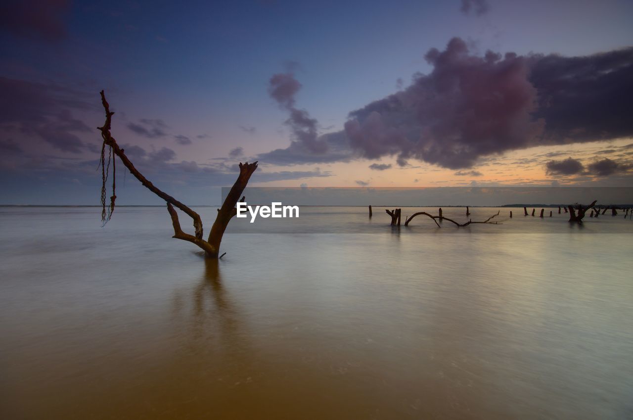 Silhouette of sea against sky during sunset