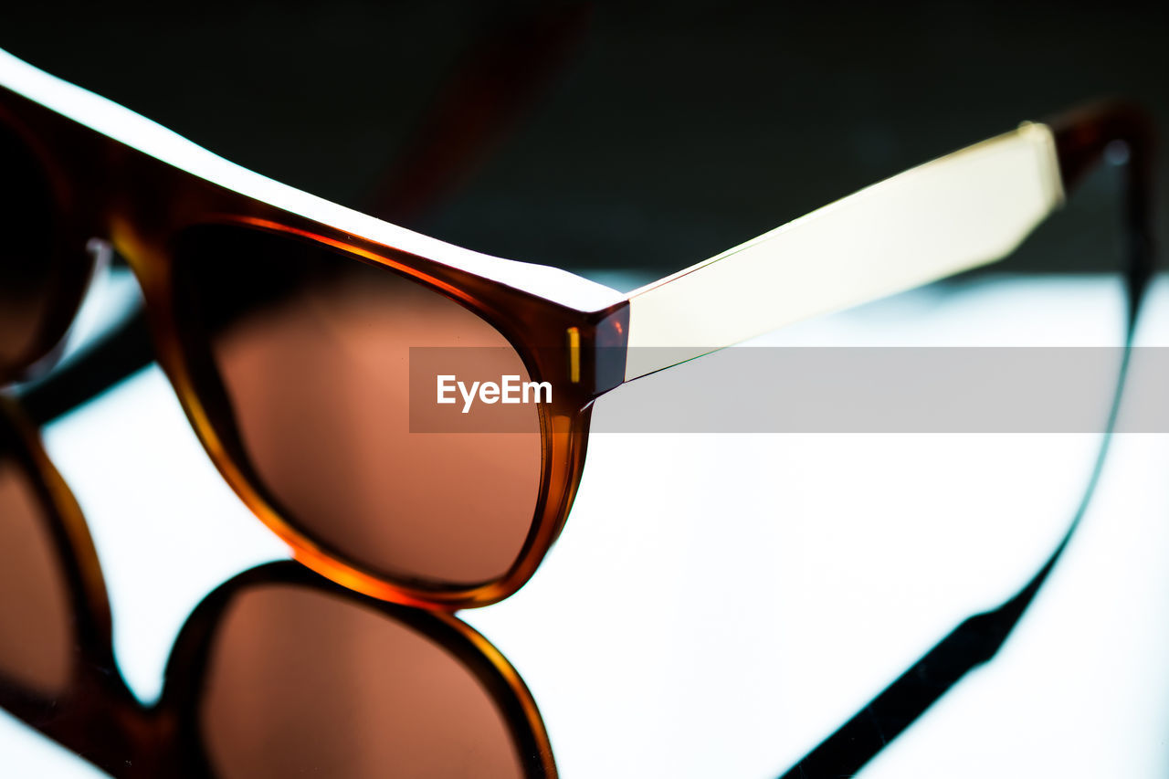 Close-up of sunglasses on mirror