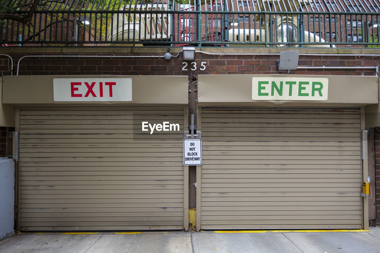 Entrance to the underground garage. gate to the garage in the building. office building is brown.