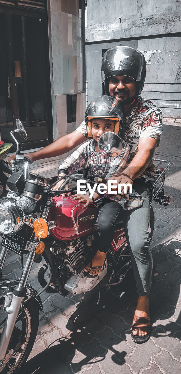 YOUNG MAN RIDING MOTOR SCOOTER ON MOTORCYCLE