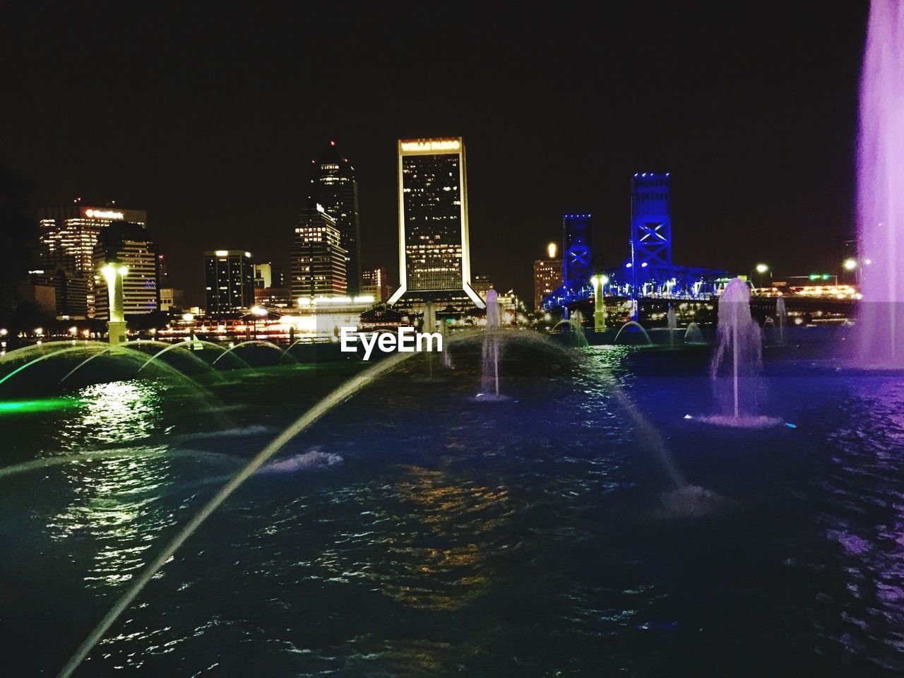 MODERN BUILDINGS IN CITY AT NIGHT